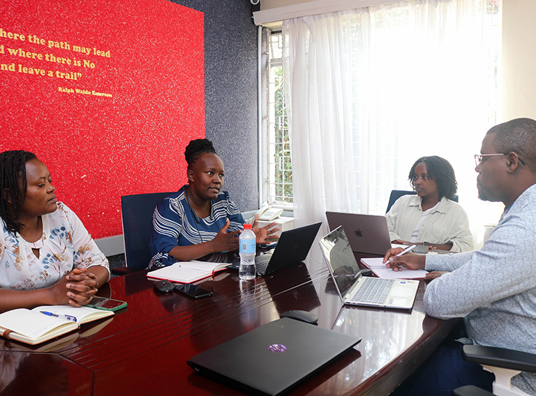 Four people discussing in a meeting in Nairobi, Kenya