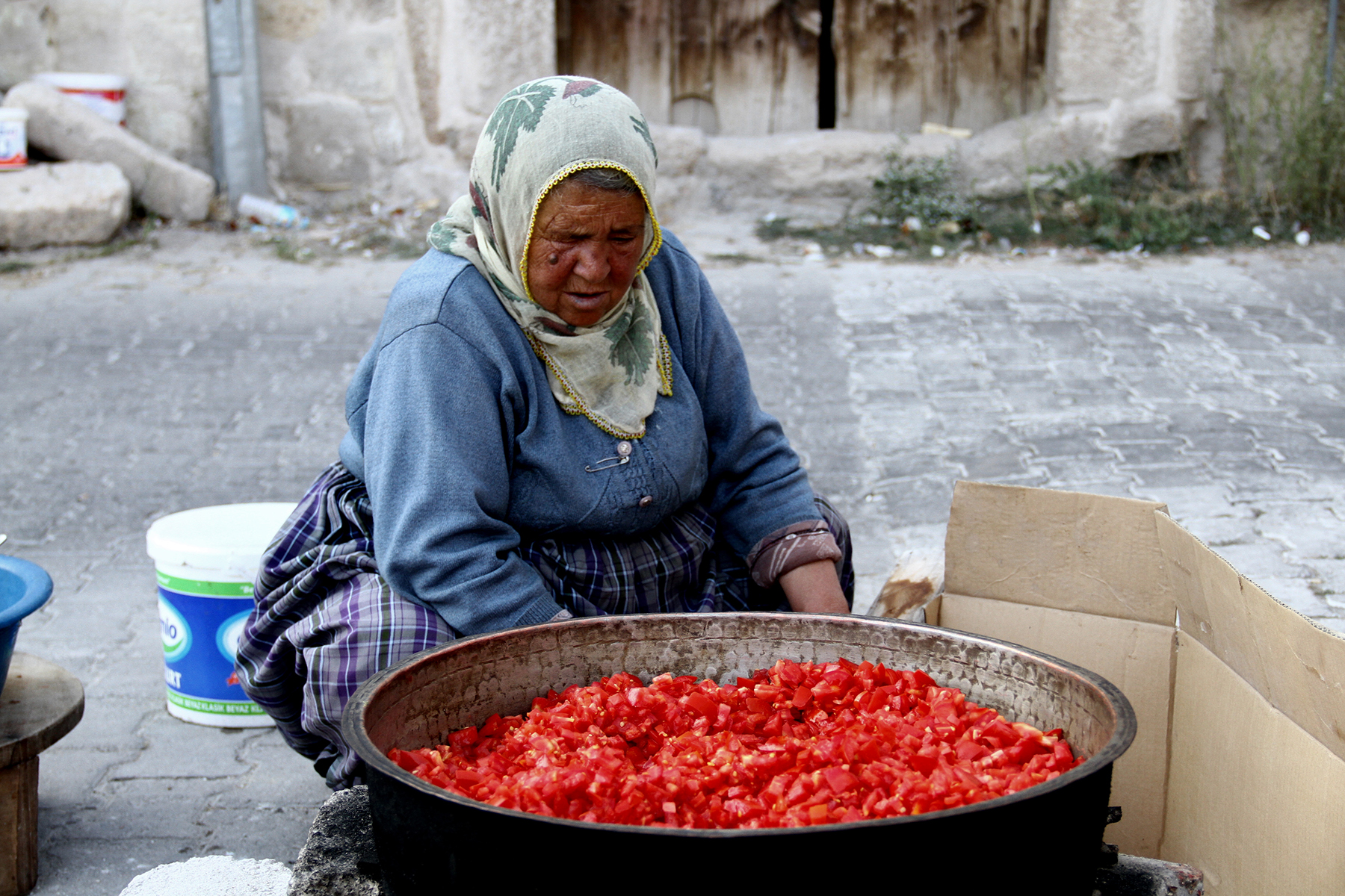 Zehra Gozer, an elderly cave dweller, prepares tomato purée (locally known as salca) for winter in Göreme village.