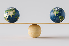 Two earth spheres on a balance